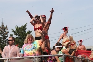 Bruce Vilanch (in tie-dye shirt) and dancers on top of a float : Provincetown Carnival parade