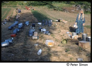 Woman in a field with buckets for harvesting, Tree Frog Farm commune