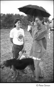 Antinuclear protesters: woman with an umbrella and dog at the Alternative Energy Coalition demonstration on Montague Plain, talking to a woman in an Alternative Energy Coalition No Nukes t-shirt