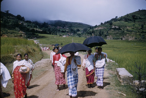 Women walk down rural road