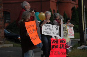 Protest against a proposed pornographic video store in Northampton: protesters with signs reading 'Feminist Action Mobilization' and 'Women are not for sale / Stop Capital Video'