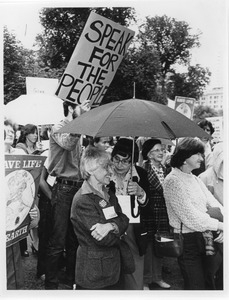 Frances Crowe and Eleanor Buerman standing under an umbrella during unidentified protest