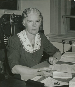 Margaret Hamlin sitting indoors, working at desk
