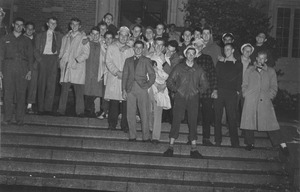 Class of 1944 members gather on the steps of a campus building