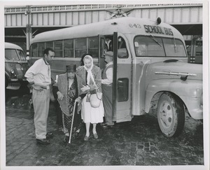 Women getting off bus at pier