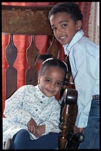 Antonio and Zena Allen (children) posed in a oversized chair