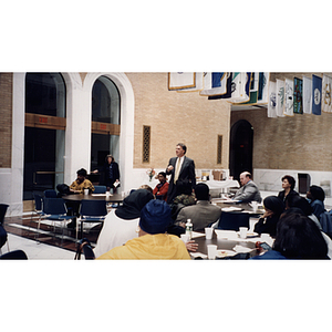 A man speaks from the audience at a town hall meeting