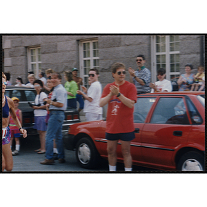 Spectators cheer on a woman running the Bunker Hill Road Race