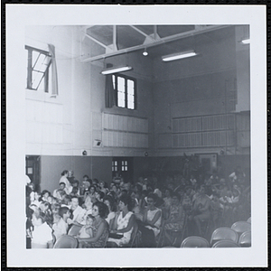Children and adults sitting in an auditorium at a Boys' Club Little Sister Contest
