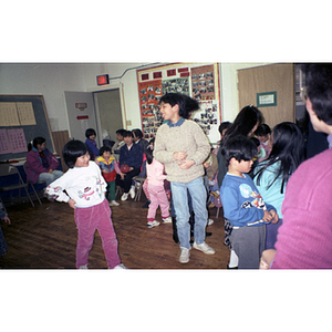 Adults and children at a Chinese Progressive Association holiday party
