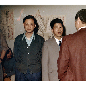 Three men stand during a gathering for the visit of the Consul General of Guangdong Province