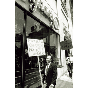 Two demonstrators picket outside Dynasty Restaurant demanding back wages for workers