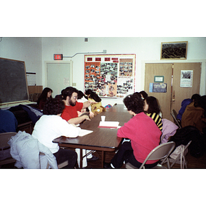 Association members sit talking at a meeting