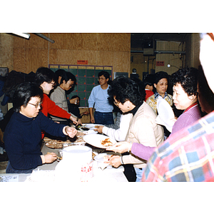 Guests get their food at the Chinese Progressive Association and garment workers' tenth anniversary celebration