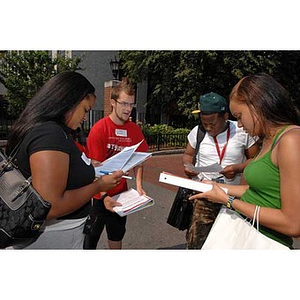 Four students gather and converse during the Torch Scholars Scavenger Hunt