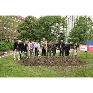 Eleven people with shovels break ground for the Veterans Memorial