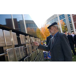 A man looks at the plaques on the Veterans Memorial at the dedication