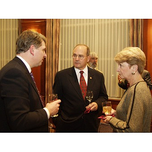 Guests with drinks conversing at the College of Business Administration's Distinguished Service Awards ceremony