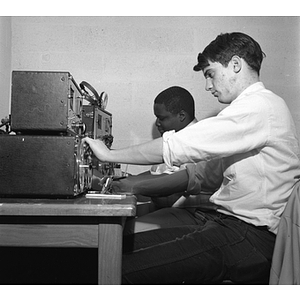 Two students at WNEU radio controls