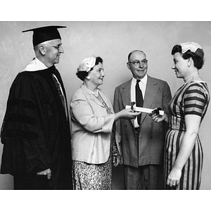 Business administration graduate, Mrs. Grace C. Johanson (right), presenting her parents with a "Certificate of Appreciation" as Dean Albert Everett (left) looks on