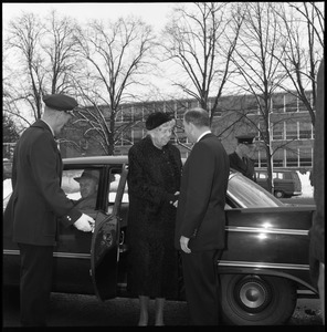 Eleanor Roosevelt (left) greeted by John Gillespie as she exits her car for her Distinguished Visitors Program appearance: Bartlett Hall in background