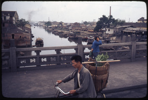 Foshan: canal, boats, bicyclist on bridge