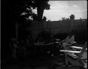 Sinclair Lewis (2nd from left) and guests, seated on the patio