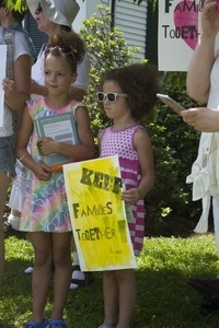 Young girls with signs at the pro-immigration rally in front of the Chatham town offices building : taken at the 'Families Belong Together' protest against the Trump administration's immigration policies