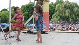 Two young girls dancing on stage at the Clearwater Festival