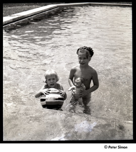 Two unidentified girls playing with a doll and inflatable ball
