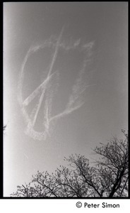 View of a skywriting peace symbol dissolving in the wind