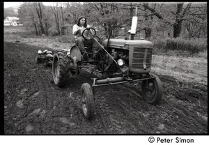 Harvey Wasserman driving a tractor, Montague Farm Commune