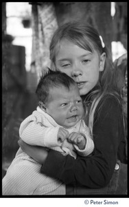 Young girl holding an infant, Lama Foundation