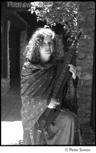 Usha (Cathy Brown): three-quarter length portrait posed with a dulcimer