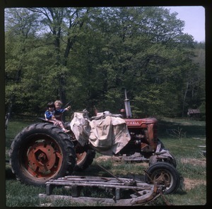 Two kids on tractor, Wendell Farm