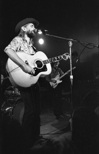 New Riders of the Purple Sage opening for the Grateful Dead at Sargent Gym, Boston University: John 'Marmaduke' Dawson playing acoustic guitar and signing, Dave Nelson in the background