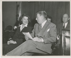Arthur Godfrey seated on stage with client at Institute Day
