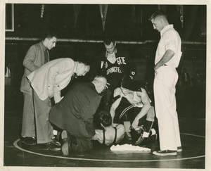 Erastus Pennock helping Springfield College Wrestler, C. 1958