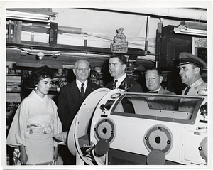 Mark Bortman with unidentified individuals and an iron lung