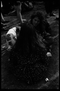 Crowd on Cambridge Common: couple seated on the grass, with puppy