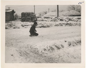Boy on knee-sled