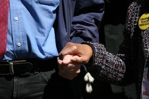 Close-up of man and woman holdings hand during the march opposing the war in Iraq