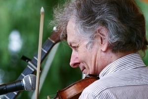 Mike Seeger (fiddle), close-up portrait, performing on stage at the Clearwater Festival