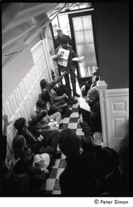 Protester distributing literature during the occupation of the University Placement Office, Boston University, opposing on-campus recruiting by Dow Chemical Co.
