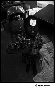 Young girl with box of chalk and sticker on her forehead, the Liberation School
