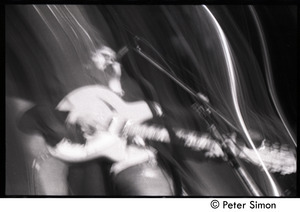 The Byrds and Flying Burrito Brothers performing at the Boston Tea Party: Roger McGuinn playing guitar (partial double exposure)