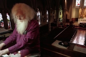 Organist Raymond Whalon, at the keyboard in an unidentified church