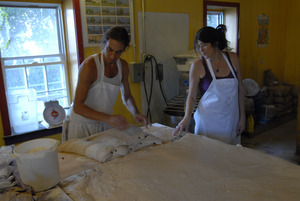 Hungry Ghost Bread: owners and bakers Jonathan C. Stevens and Cheryl Maffei working dough for cinnamon rolls