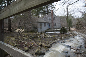 Sheffield House: view of a stream and restored post and beam house, Sheffield, Mass.