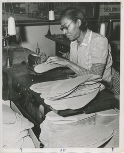 Jonnie Mae Swain using a sewing machine at a sheltered workshop